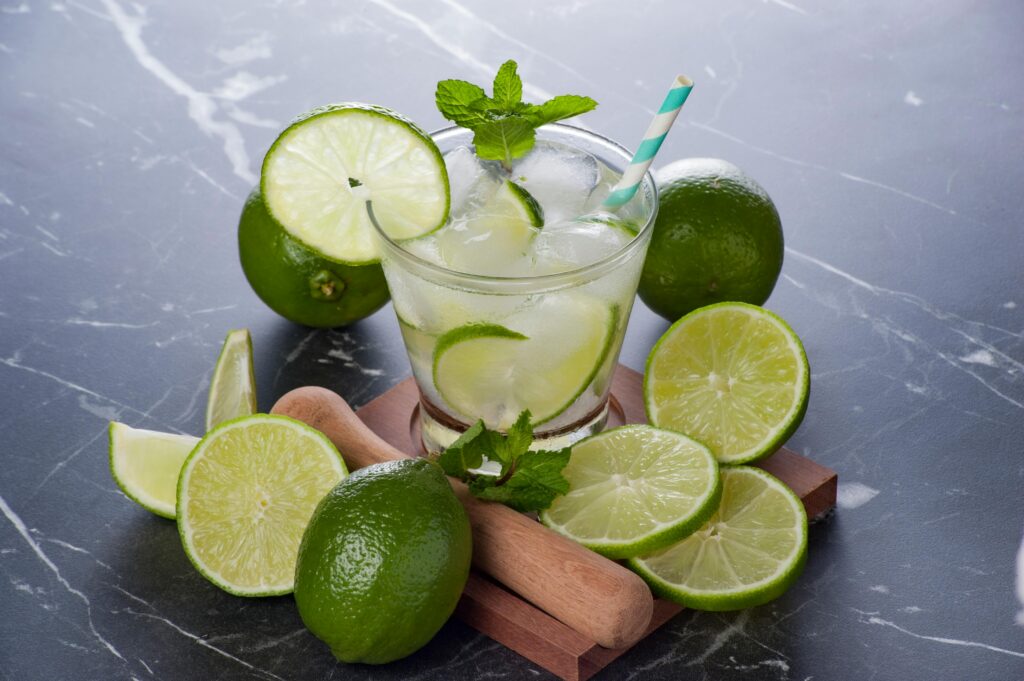 A chilled caipirinha with fresh limes and ice, perfect summer cocktail.